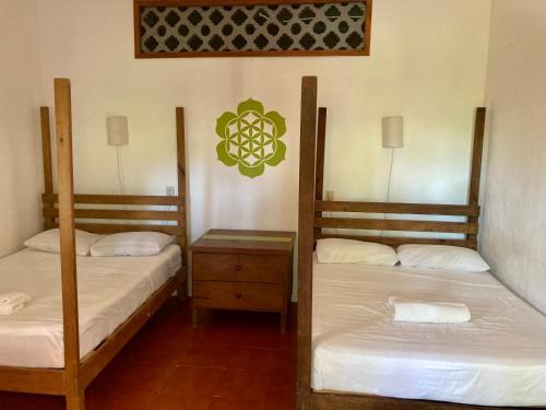 due letti a castello in una stanza con lenzuola bianche di Posada Paloma a San Agustinillo
