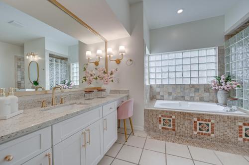 a bathroom with a large tub and a sink and a tub at Exciting Valrico Villa with Private Pool and Game Room in Valrico