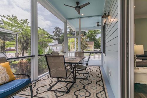 a screened in porch with a table and chairs at Newly Listed Duke St Cottage - Downtown Beaufort in Beaufort
