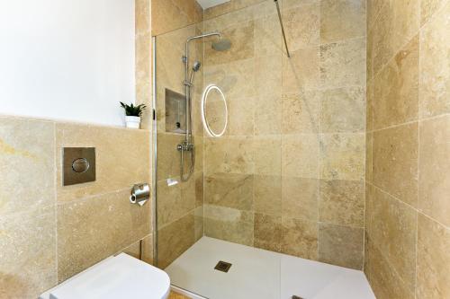 a bathroom with a shower with a toilet at CasaCarbonito in Carboneras