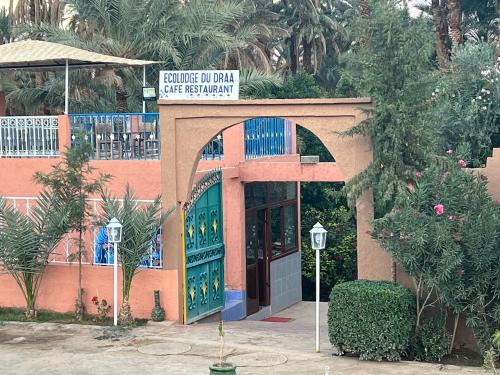 a building with a sign on top of it at Ecolodge du Draa in Ouled Otmane