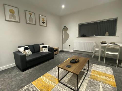 a living room with a couch and a table at 1 bedroom apartments in Bolton town centre in Bolton