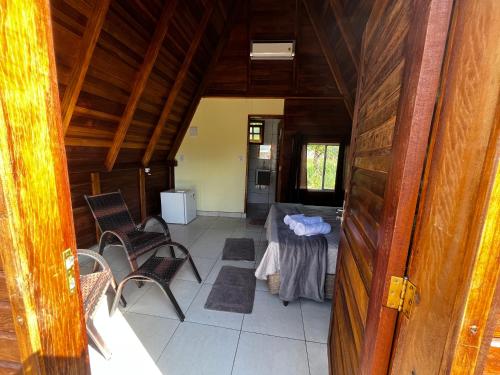 a view of a room with a table and chairs at Chalé da Chapada in Chapada dos Guimarães