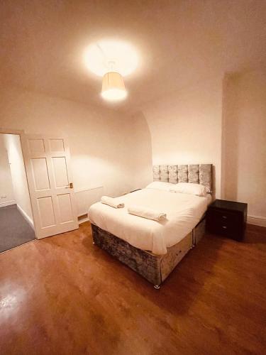 a bedroom with a bed and a white door at BIG SPACIOUS 2 BEDROOM HOUSE, SLEEPS 8, FREE STREET PARKING, EASY ACCESS LOCK BoX ENTRY, NO PARTIES! in Liverpool