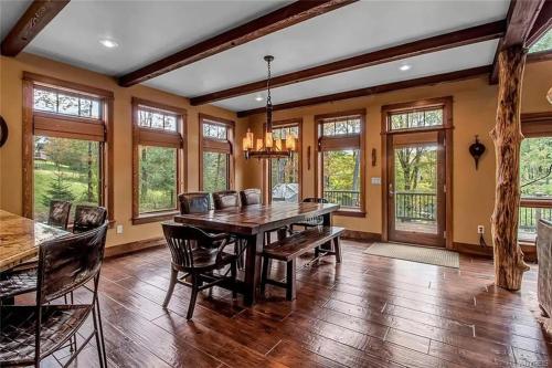 a dining room with a wooden table and chairs at Luxurious Chalet! Hot-tub, Bonfire & Ideal Location for Skiing & Town in Ellicottville
