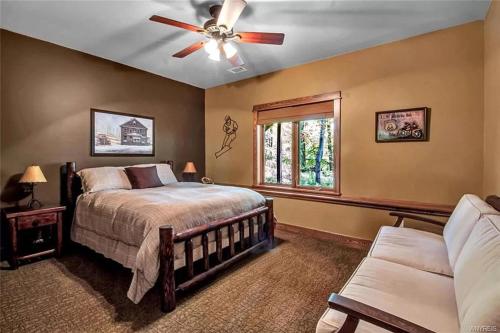 a bedroom with a bed and a ceiling fan at Luxurious Chalet! Hot-tub, Bonfire & Ideal Location for Skiing & Town in Ellicottville