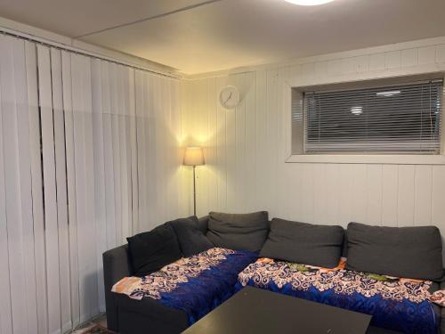 a living room with a couch and a window at Råstadveien 20 in Sandefjord