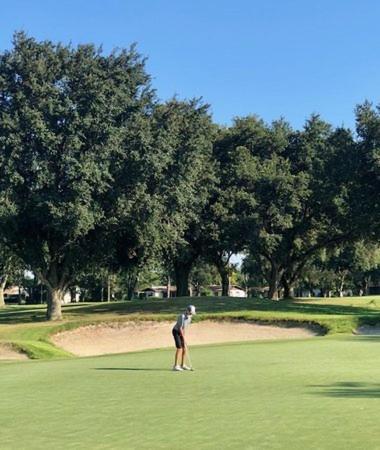 a man is standing on a golf course at Private Centrally located Cozy relaxing Getaway! in Deltona