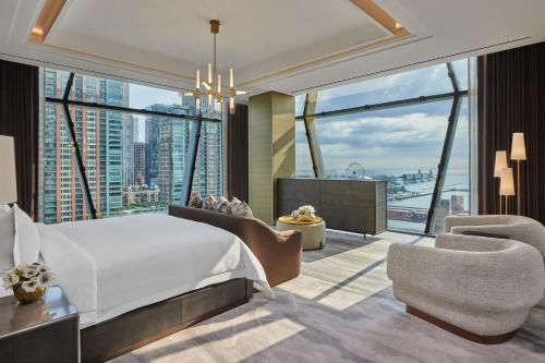 a bedroom with a large bed and a large window at The St. Regis Chicago in Chicago