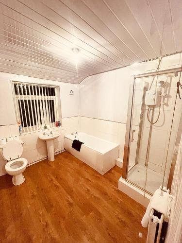 a bathroom with a tub and a toilet and a sink at BIG SPACIOUS 2 BEDROOM HOUSE, SLEEPS 8, FREE STREET PARKING, EASY ACCESS LOCK BoX ENTRY, NO PARTIES! in Liverpool