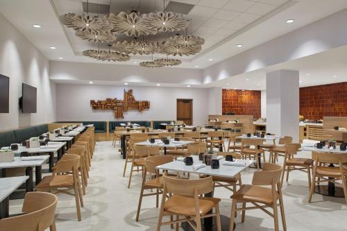 a large dining room with tables and chairs at Sheraton Denver Downtown Hotel in Denver