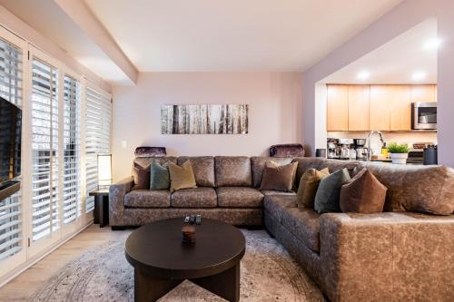 a living room with a couch and a table at Sunpath by Outpost Whistler in Whistler
