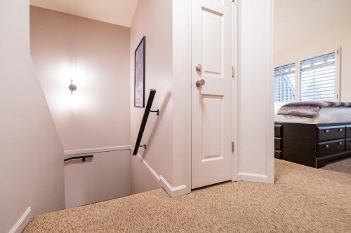 a hallway with a door leading to a bedroom at Sunpath by Outpost Whistler in Whistler