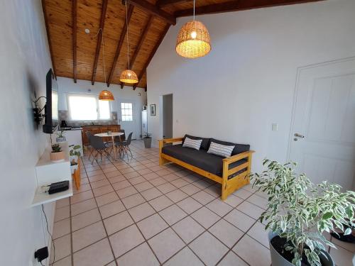 a living room with a couch and a table at Ventanas de la Patagonia 3 in Esquel