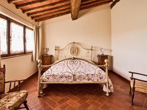 a bedroom with a bed in a room with windows at Spacious apartment in villa with pool in Cavriglia