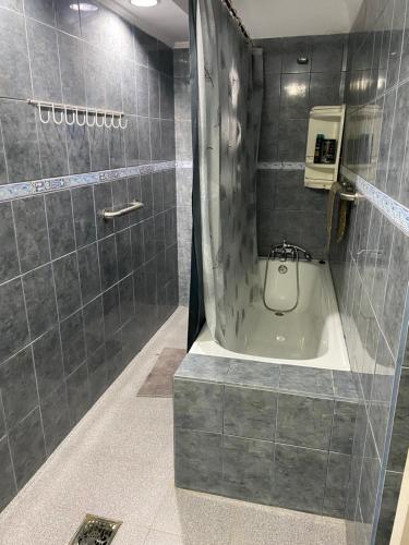 a bathroom with a shower and a bath tub at Suite Loreto in Caldera