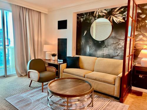a living room with a couch and a table at Blu Cashmere Suite * MGM Signature 23rd FLR w/balcony strip view in Las Vegas