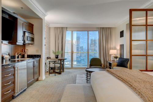 a hotel room with a large bed and a kitchen at Blu Cashmere Suite * MGM Signature 23rd FLR w/balcony strip view in Las Vegas