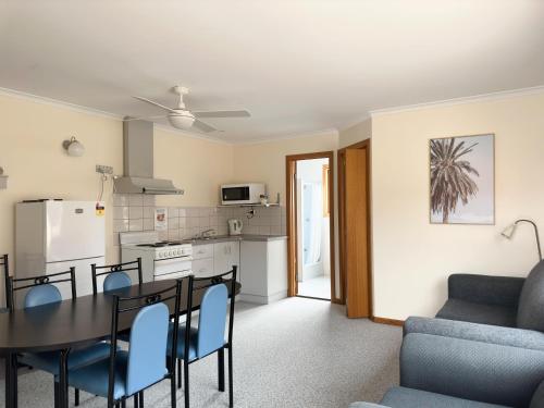 a kitchen and dining room with a table and chairs at Port Vincent Motel & Apartments in Port Vincent