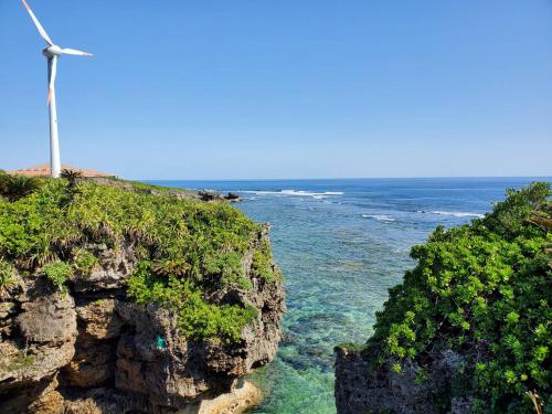 a wind turbine on a cliff near the ocean at Ocean Villa Okinoerabu in Wadomari