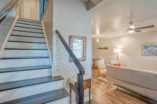 a staircase in a living room with a stair case at Downtown Beaufort Townhome - Short walk to Waterfront Park - Less than 10 minutes to Parris Island in Beaufort