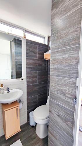 a bathroom with a toilet and a sink at Villa Quintero202 in Santa Rosa de Cabal
