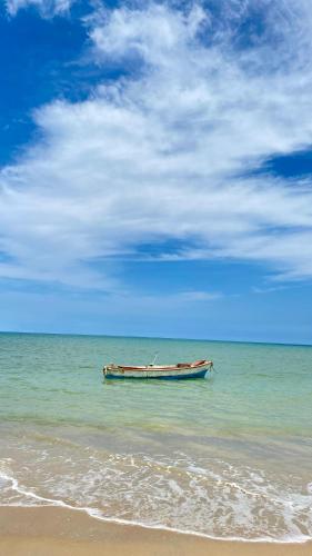 a boat sitting in the water on the beach at Guajira Beach in Ríohacha
