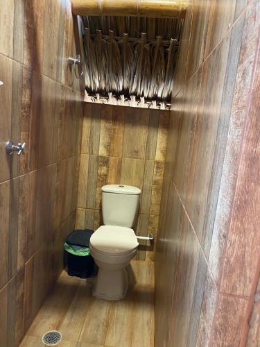 a bathroom with a toilet in a wooden stall at Guajira Beach in Ríohacha