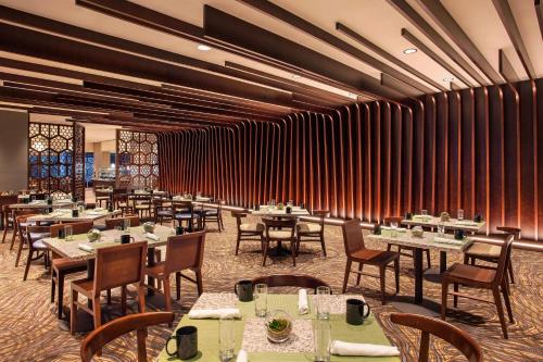 a dining room with tables and chairs and curtains at The Westin Peachtree Plaza, Atlanta in Atlanta