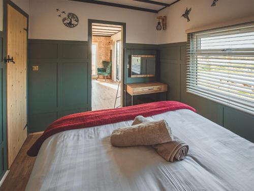 a bedroom with a bed with two towels on it at Cedar Lodge -uk44425 in Donyatt