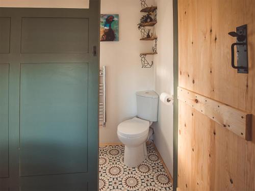 a bathroom with a toilet and a glass door at Cedar Lodge -uk44425 in Donyatt