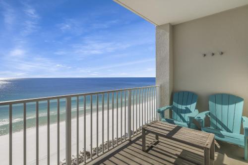 a balcony with two chairs and a view of the ocean at Majestic Sun Resort by Tufan in Destin