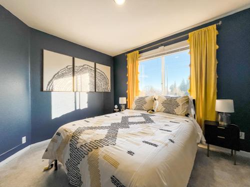 a bedroom with a large bed and a large window at Rose City House in Portland