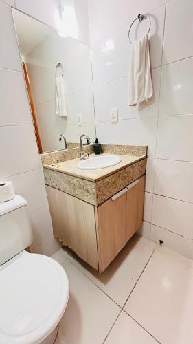 a bathroom with a sink and a toilet at Flat Tambaú - Beira-mar in João Pessoa