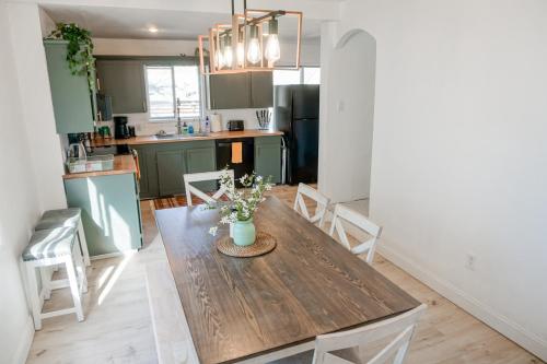 a kitchen with a wooden table in a room at Rose City House in Portland