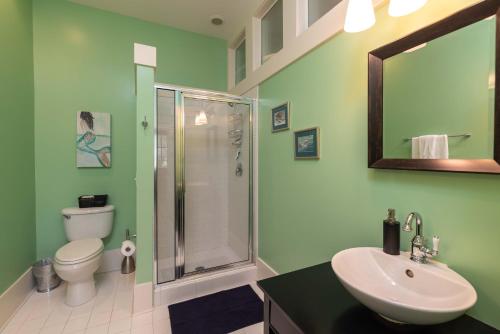a green bathroom with a sink and a shower at Cherokee Farms Flat - New Listing in Habersham in Beaufort