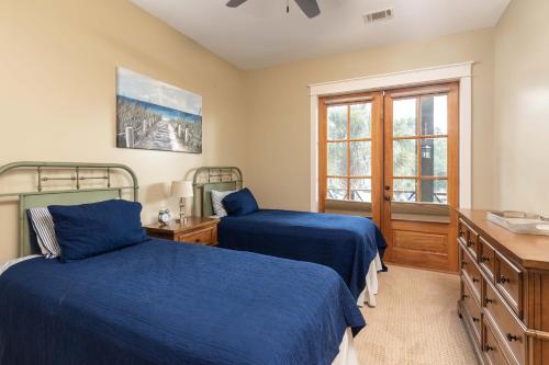 a bedroom with two beds and a window at Cherokee Farms Flat - New Listing in Habersham in Beaufort