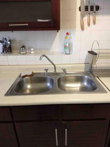 a stainless steel sink in a kitchen at Depto Espacioso con hermosa vista a min del Centro Histórico de la Cdmx in Mexico City