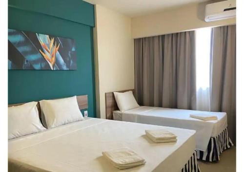 um quarto de hotel com duas camas e uma parede azul em Suite Deluxe Enjoy Solar- 5 pessoas em Olímpia