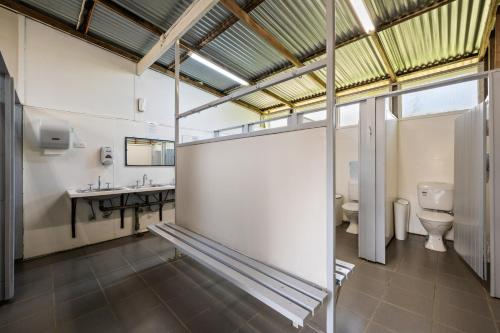 a bathroom with a toilet and a sink at Bright Cabin Park in Bright