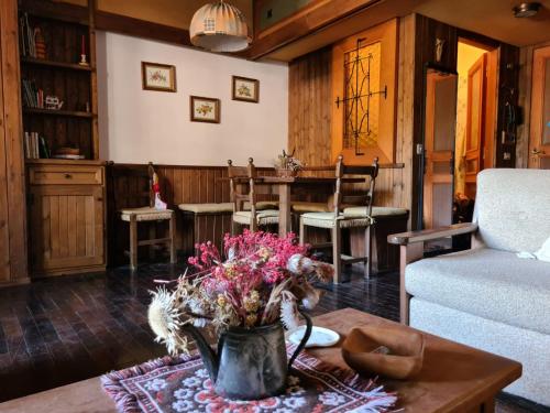 a living room with a table and a couch at Monolocale Pescasseroli Residence Palace in Pescasseroli