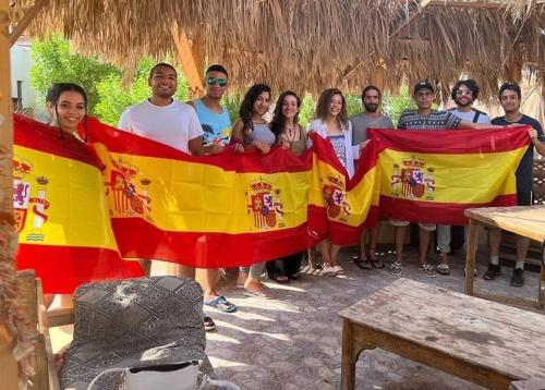 a group of people holding a large flag at November Camp in Dahab