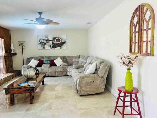 a living room with a couch and a table at Vintage Family Scape + heated pool&discount in Tampa