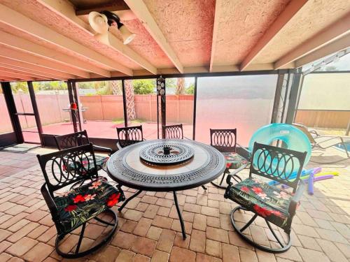a patio with a table and chairs on a patio at Vintage Family Scape + heated pool&discount in Tampa