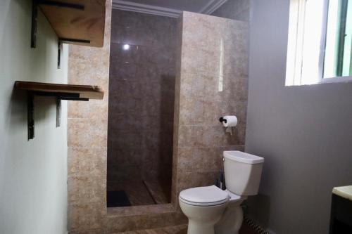 a bathroom with a toilet and a shower at Riverside Lodge 