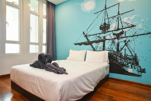 a bedroom with a bed with a pirate ship on the wall at 1Medini Theme Suite by Nest Home【LEGOLAND】 in Nusajaya