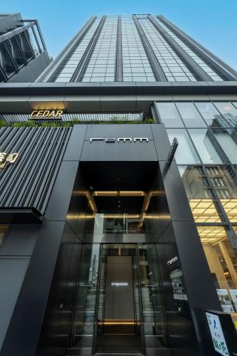 an entrance to a building with a glass facade at remm Roppongi in Tokyo
