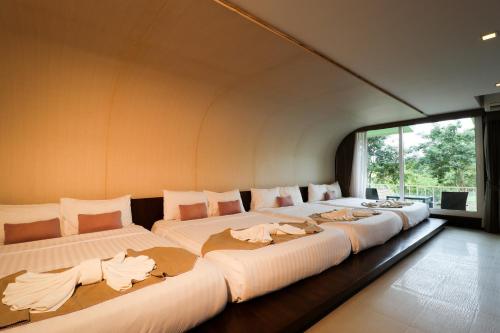 Un ou plusieurs lits dans un hébergement de l'établissement Suan Sai Yok Resort