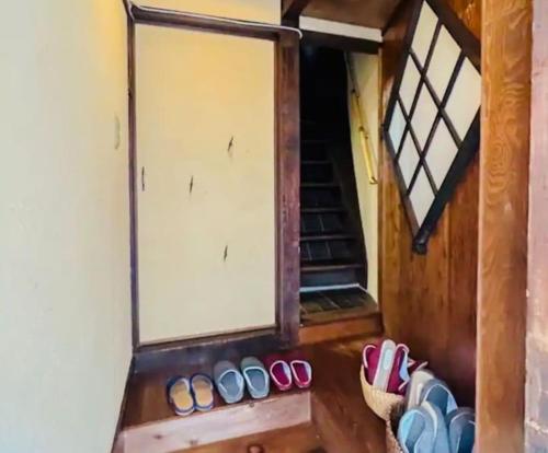 a group of shoes sitting in front of a door at ローカルプライド朝潮橋忍者ハウスからくり忍者ハウスにステイ in Osaka