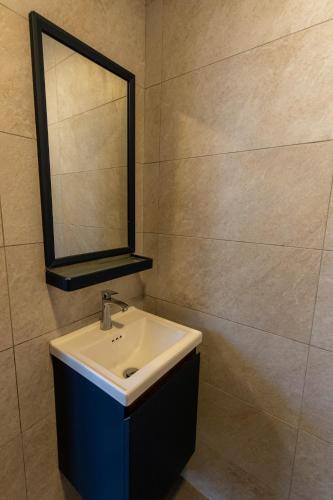 a bathroom with a sink and a mirror at 15Px 5BR V Jaccuzi Spa n KTV n Pool Table At Georgetown, USM n Lam Wah Ee Hospital -Kids pool no more in Gelugor